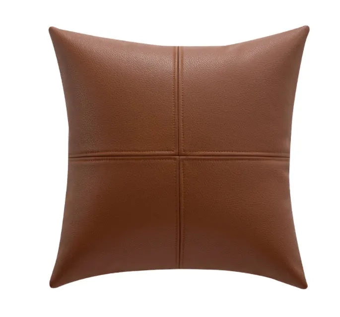 Soft cowhide leather pillow cover in a solid colour, shown in a Nordic-style room setting.