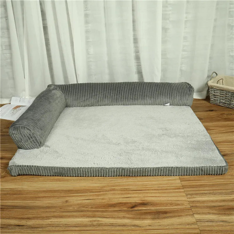 Corduroy dog bed sofa with bolster sides and non-slip base in a neutral colour.