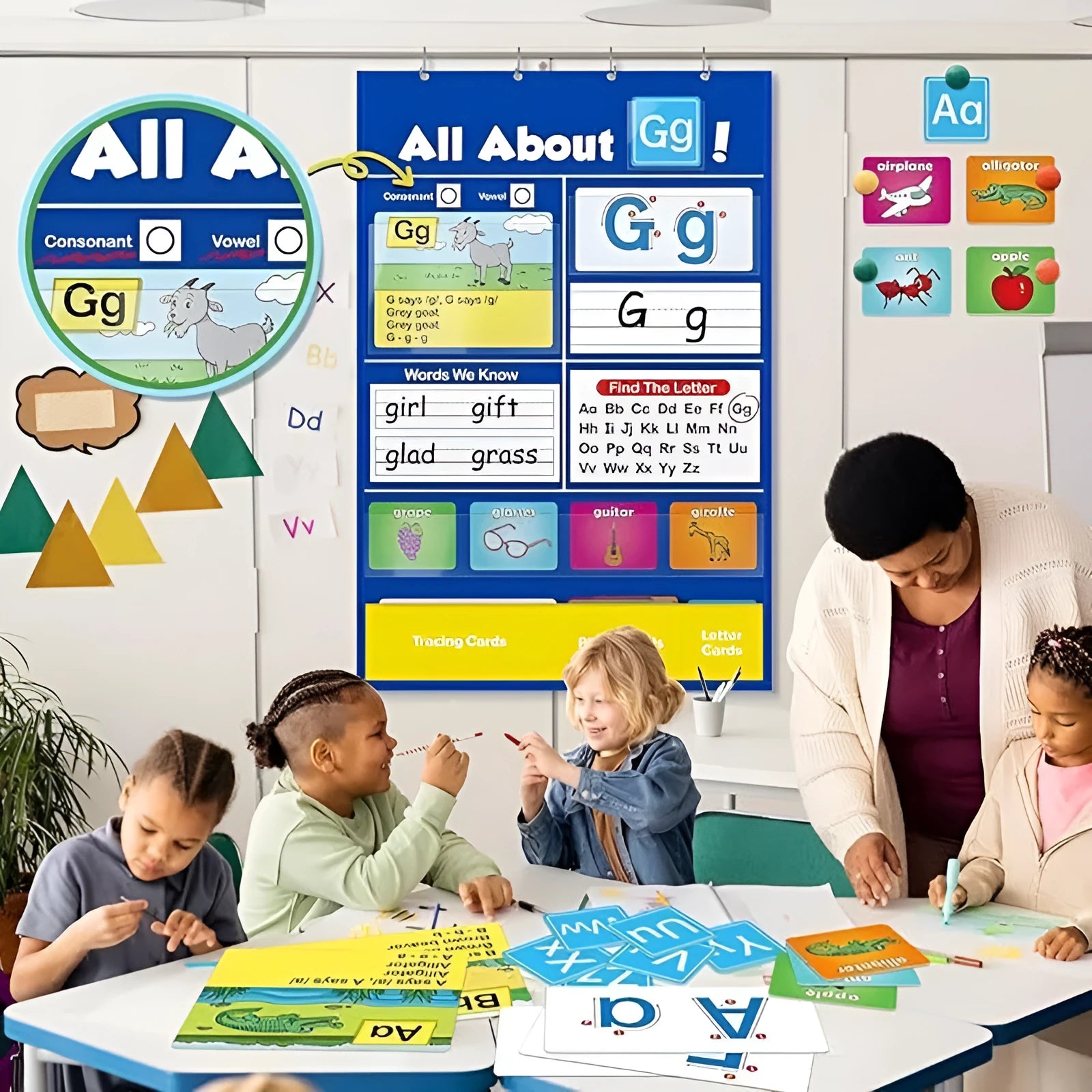Blue alphabet learning sleeve table with word and letter cards laid out on its wipeable PVC surface.