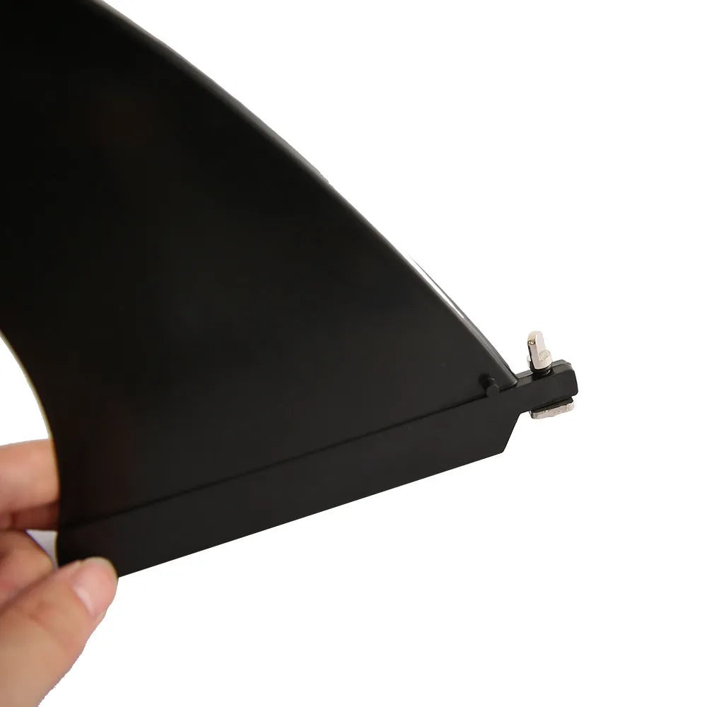 SUP paddle with large removable fish fins showing screw attachment mechanism