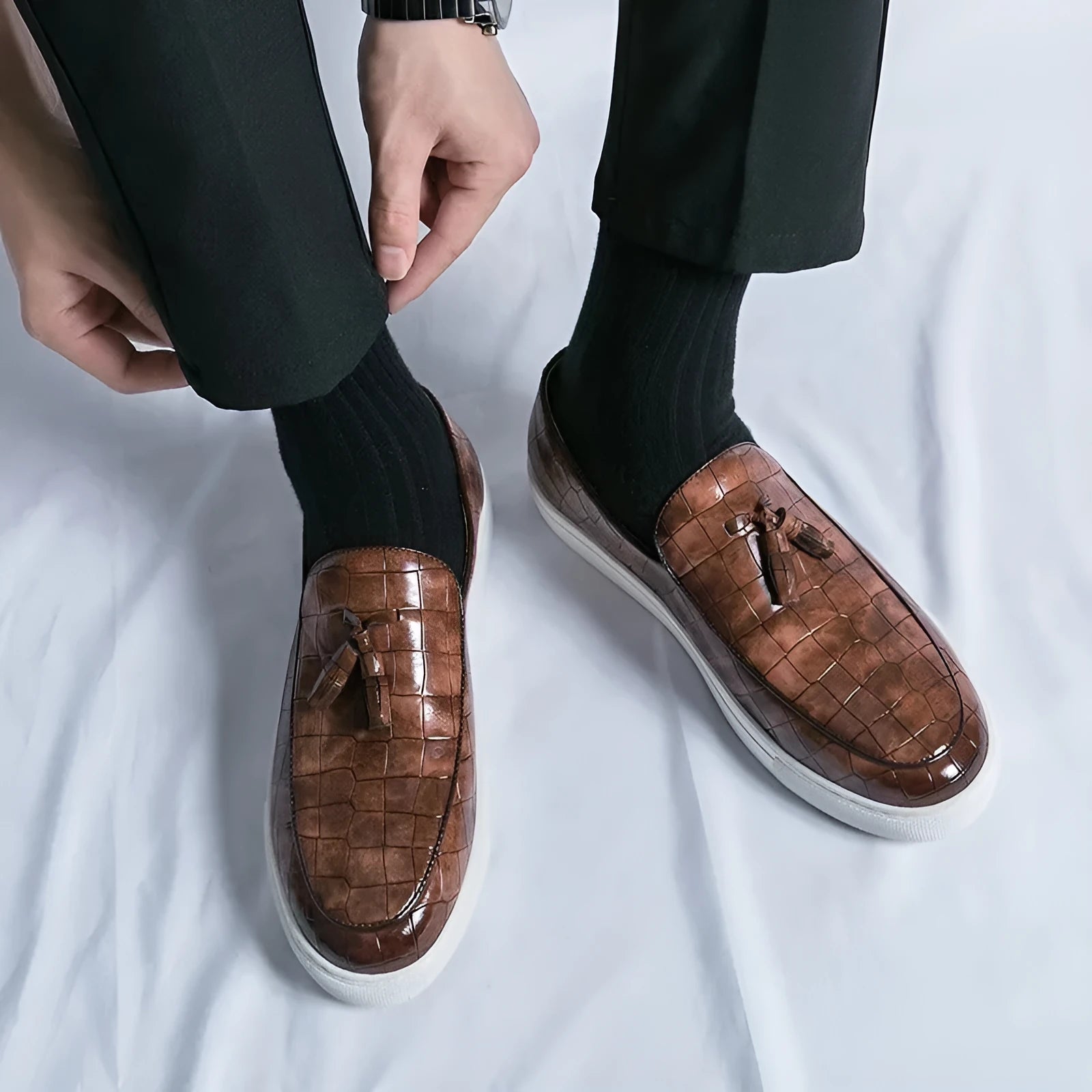 Men's black casual sneakers with a tassel detail on the artificial PU upper and a round toe.