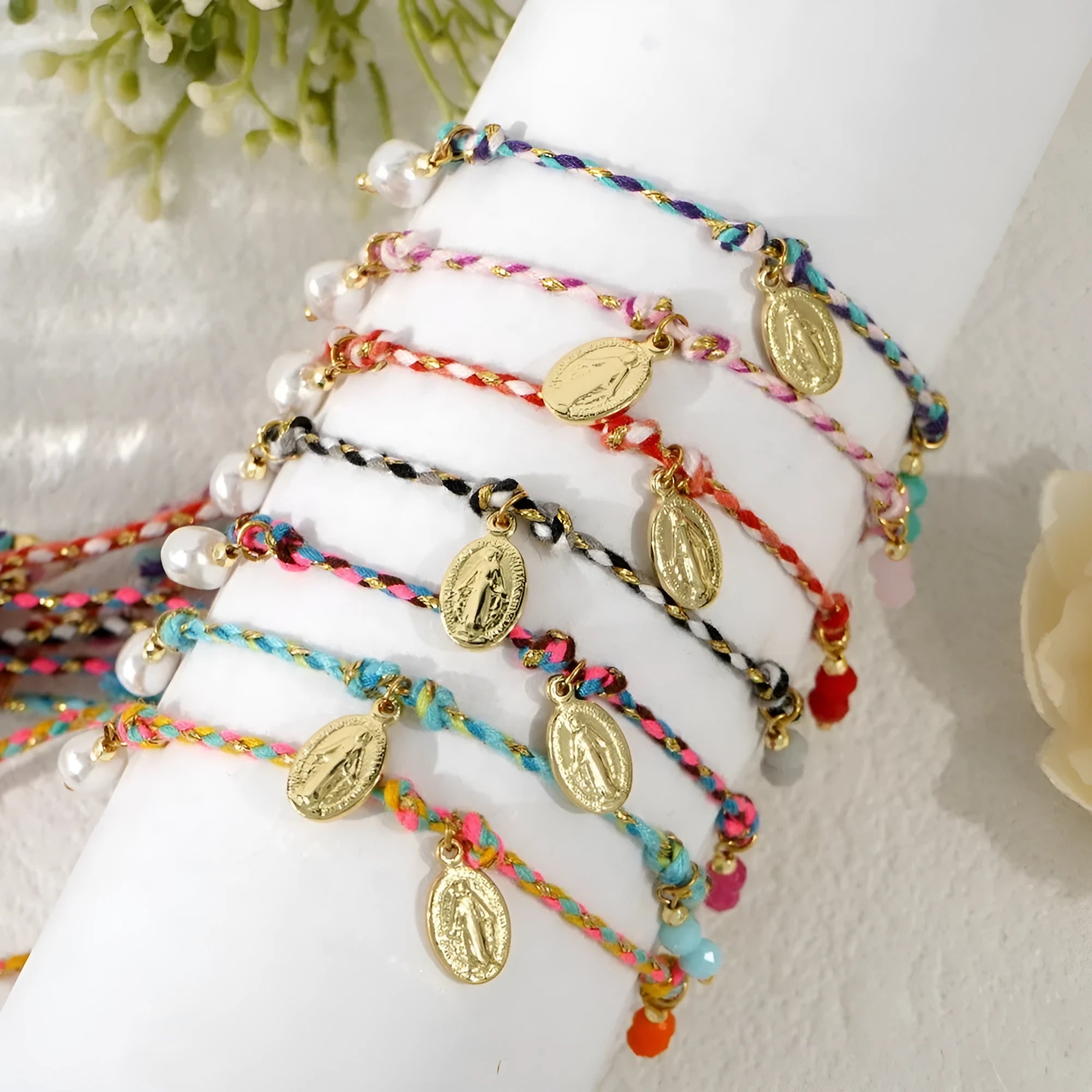 Close-up of a hand-woven colourful braided rope bracelet with an adjustable strap tag closure.