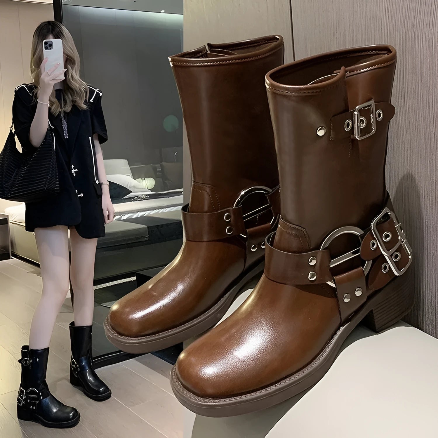 Black platform boot with buckle strap on mid-calf shaft, displayed next to brown version.