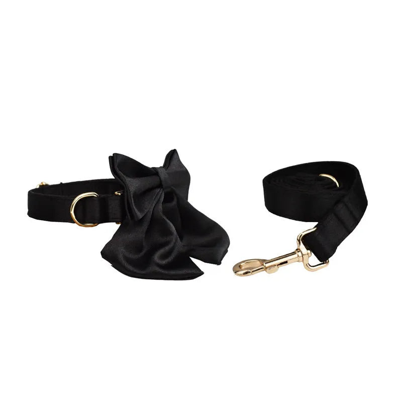 Fabric dog collar and lead set with matching chest strap vest and decorative bow tie.