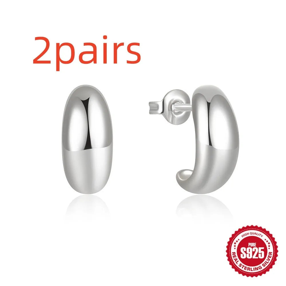 Sterling silver C-shaped stud earrings with glossy electroplated finish in gold or silver tone