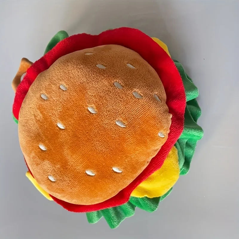 A soft plush burger-shaped headdress collar for a cat or small dog on a white background.