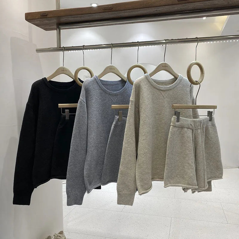 Women's loose grey knitted sweater and wide leg shorts two-piece loungewear set.