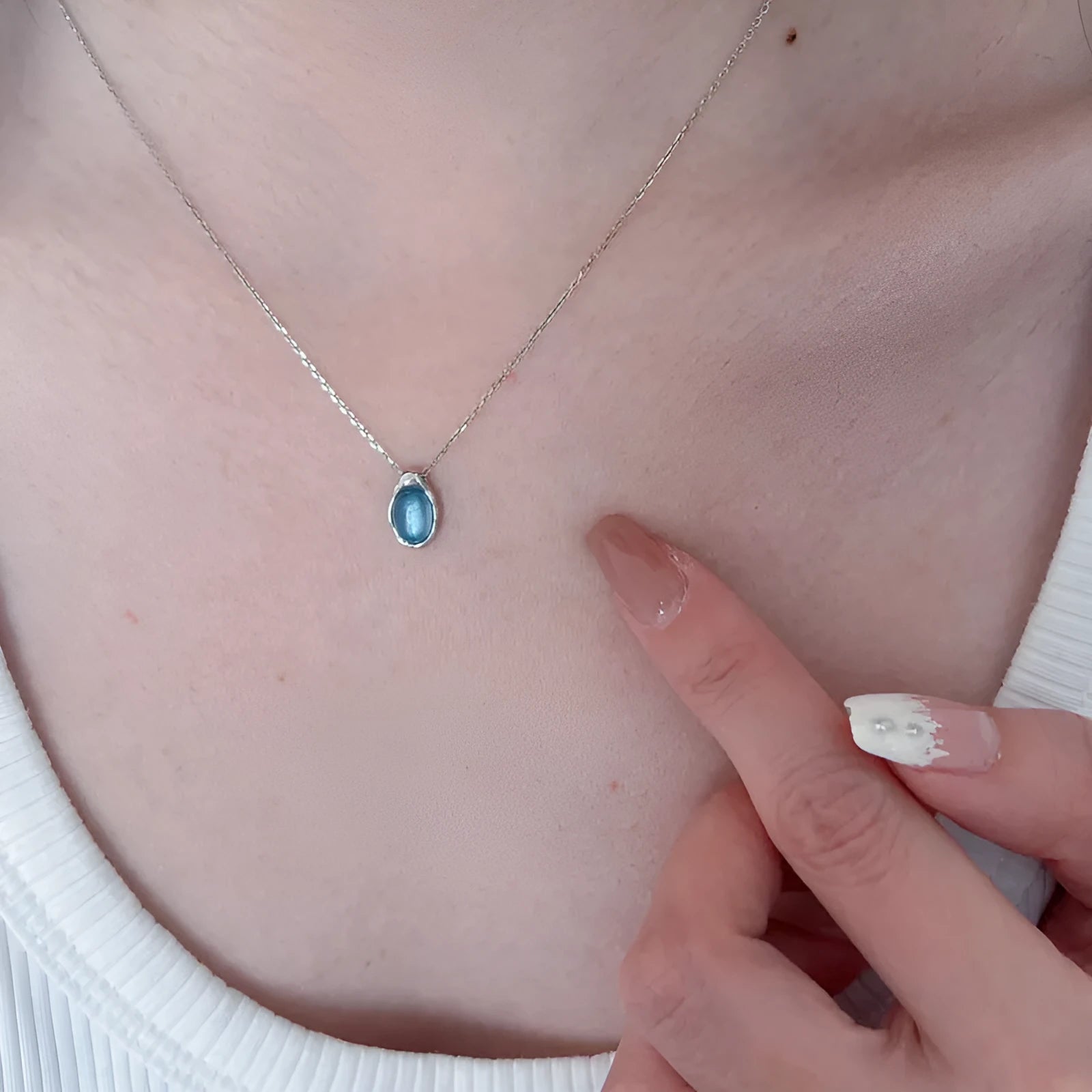 Women's navy blue geometric water drop necklace on adjustable cross chain