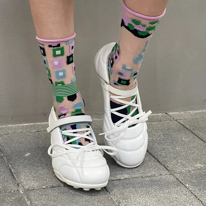 Women's silver lace-up sports shoes with a bow detail on the front, showing a low-top and round toe design.