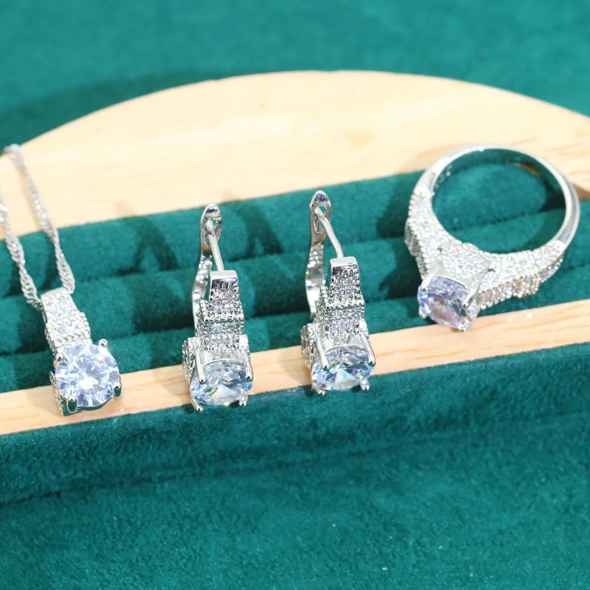 Bridal zircon four-piece jewellery set with necklace, earrings, bracelet, and ring in water wave chain style.