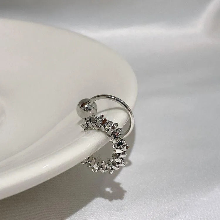 Geometric irregular shaped frosty finish alloy ear clip earrings with a double clip mechanism.