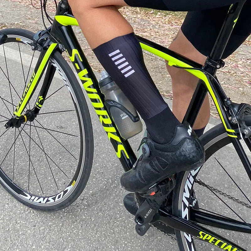 A pair of breathable athletic cycling socks in a chemical fibre blend, shown in one of six available colours.