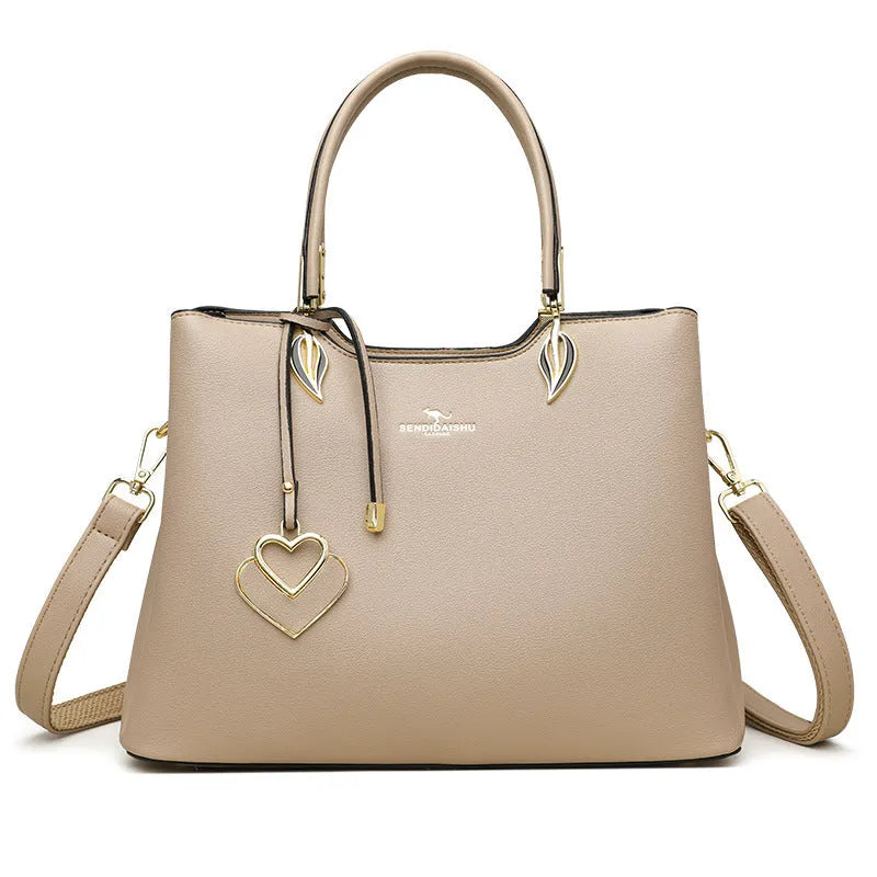 Women's black PU messenger bag with multi-layer design and visible sewing thread detail.