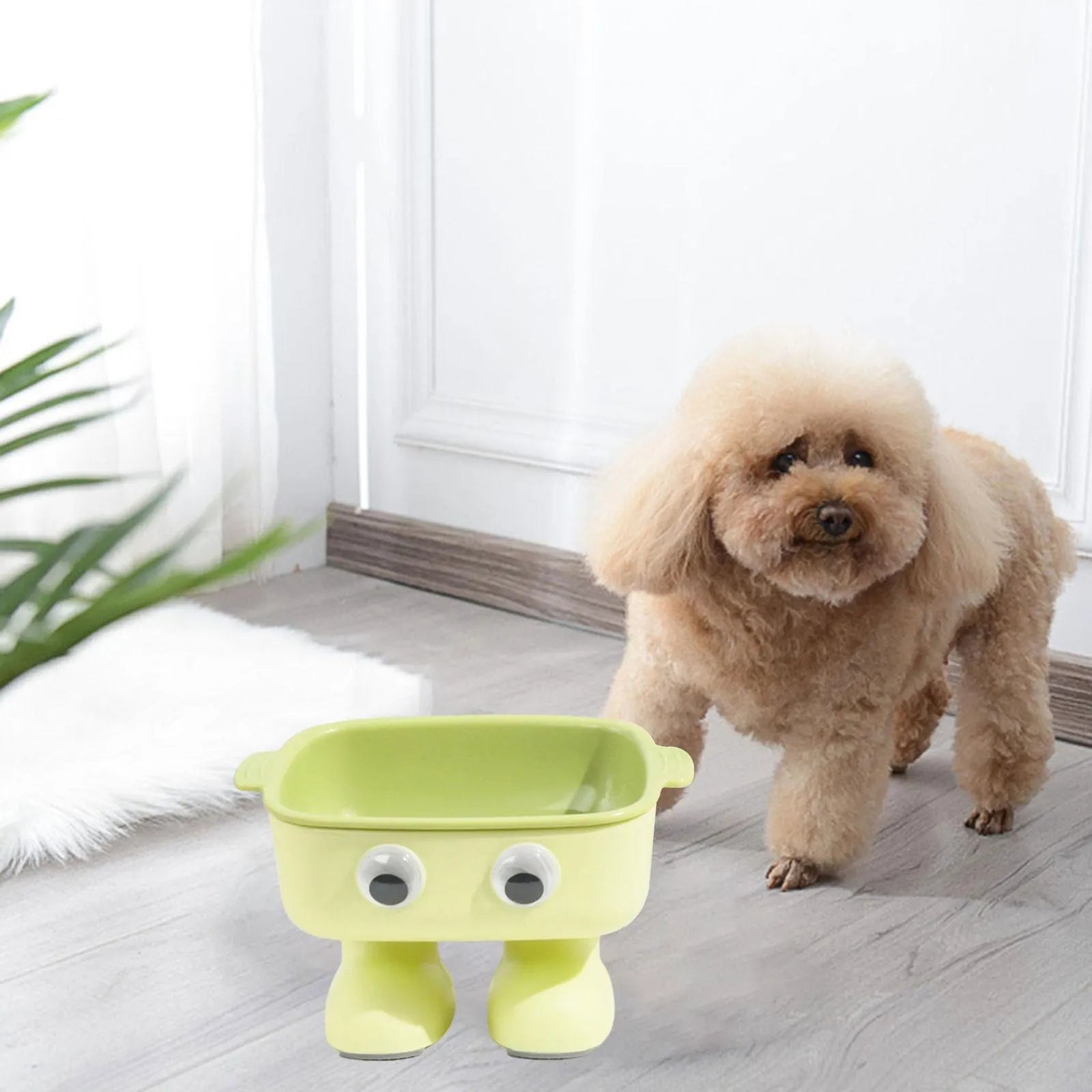 Green robot-shaped elevated cat bowl with tilted design and detachable inner component