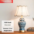 Handmade blue and white Chinese porcelain ceramic table lamp with copper base and fabric shade.