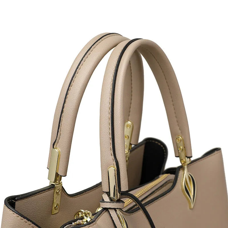 Women's black PU messenger bag with multi-layer design and visible sewing thread detail.