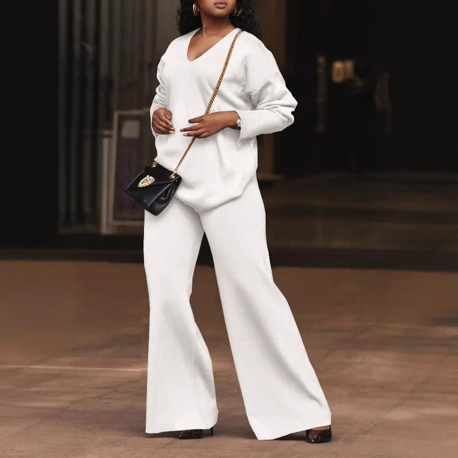 Women's brown suede two-piece suit with split sleeve detail on the long-sleeved top and matching trousers.