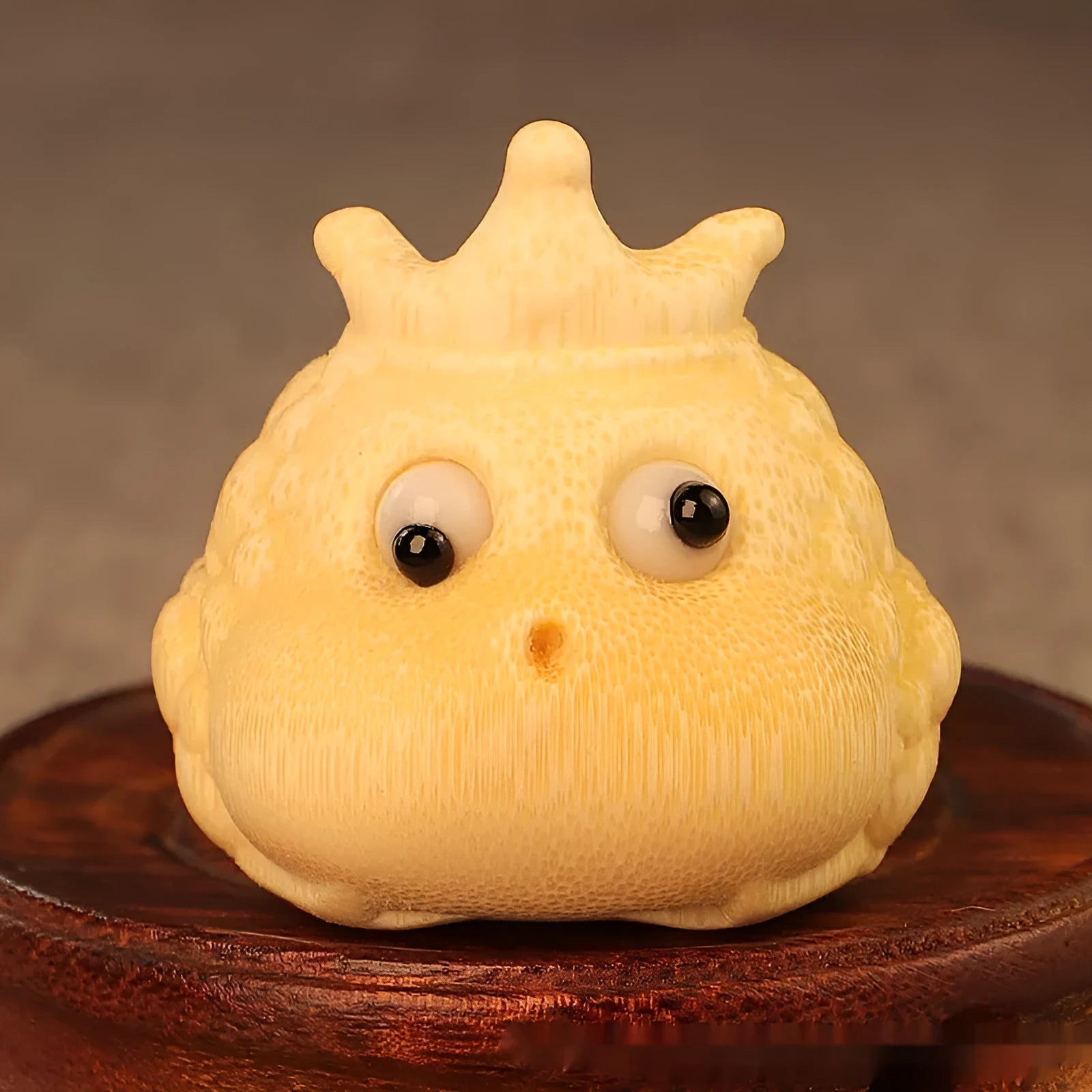 Close-up of a 5 cm cute Crown Princess Toad ornament carved from solid bamboo.