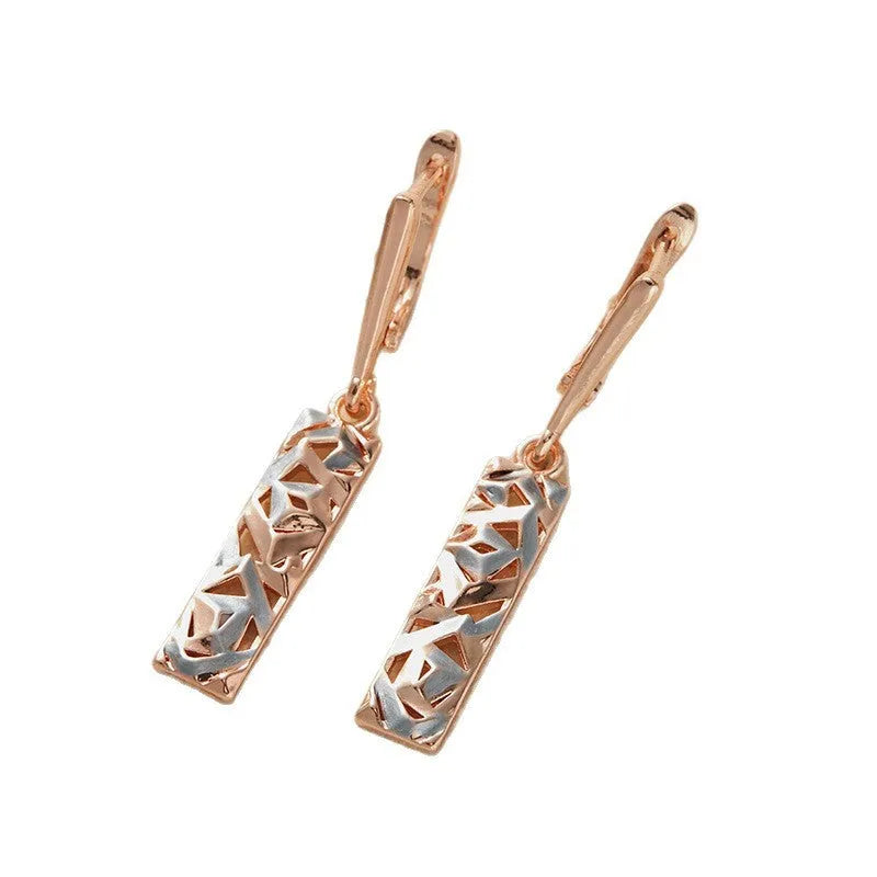 Close-up of women's rectangular hollow two-tone alloy stud earrings on a white background.