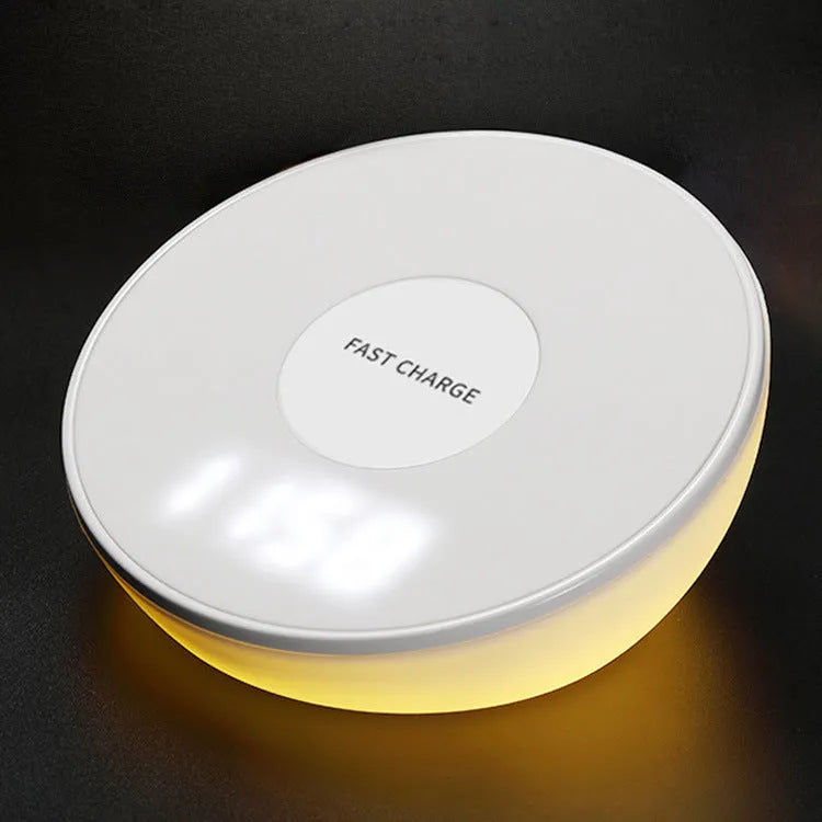 White wireless phone charger with digital clock display showing time, measuring 115mm long