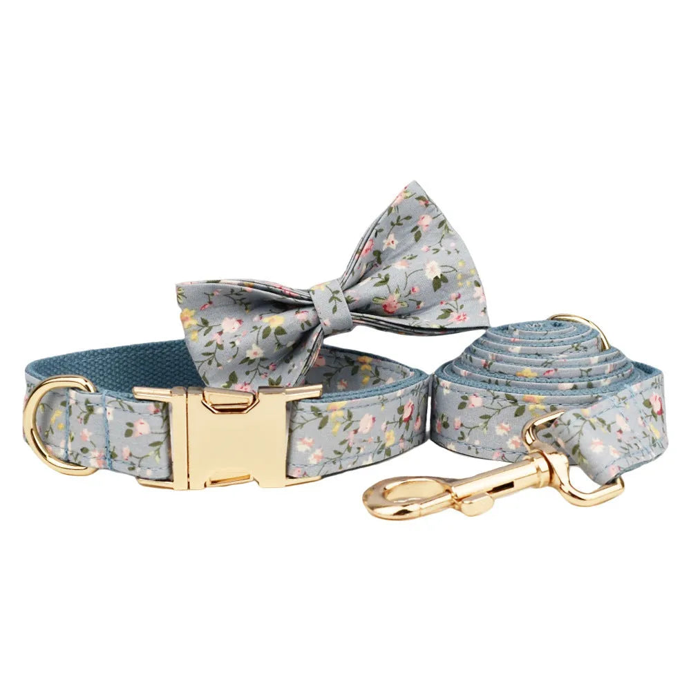 Blue floral pattern dog collar set with matching accessories including bow, leash and vest