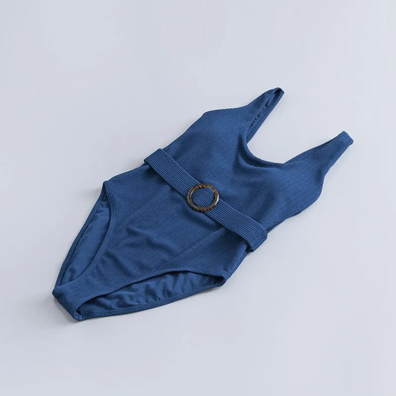 Women's navy blue solid colour one-piece swimsuit with triangle shape and chest pads on a mannequin.