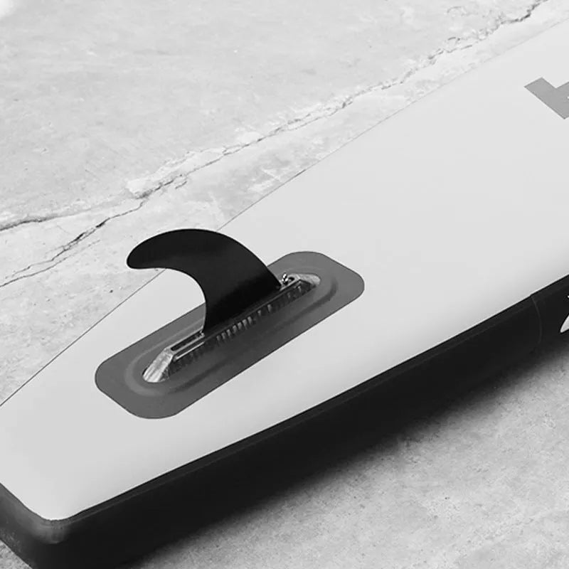 SUP paddle with large removable fish fins showing screw attachment mechanism
