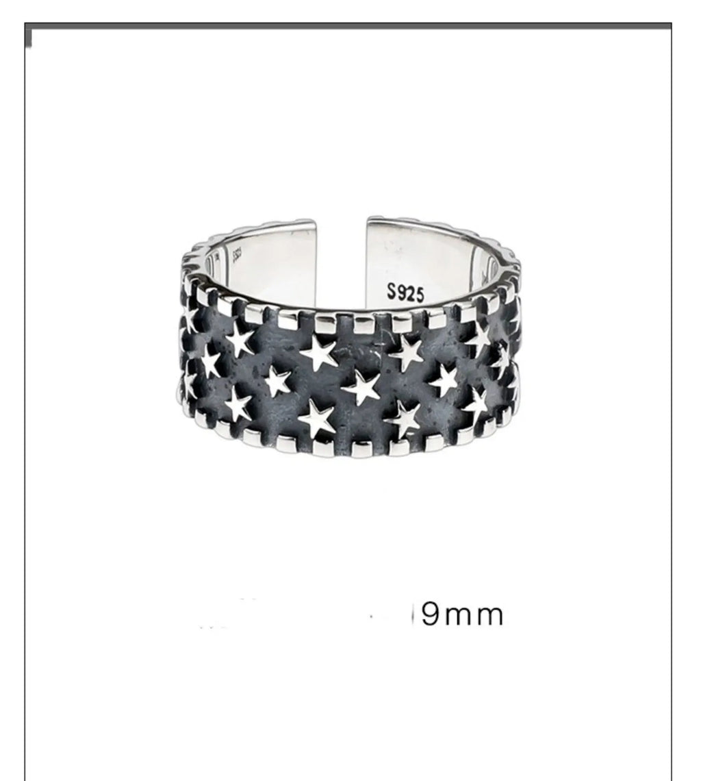 Adjustable open-back sterling silver ring with a raised five-pointed star geometric pattern.