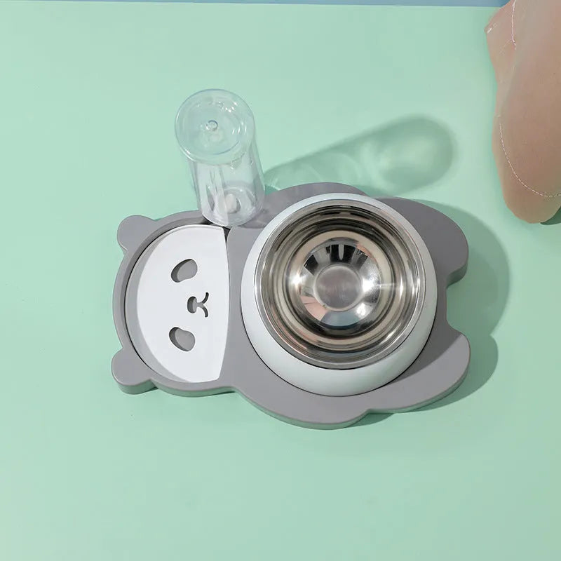 Grey elevated pet feeder with tilted stainless steel bowls and a panda-shaped automatic water bottle for cats and small dogs.
