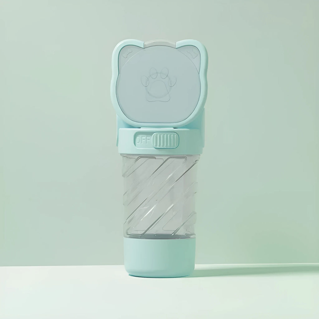 Green 3-in-1 portable pet water bottle with food container and waste bag dispenser, held by its hand strap.
