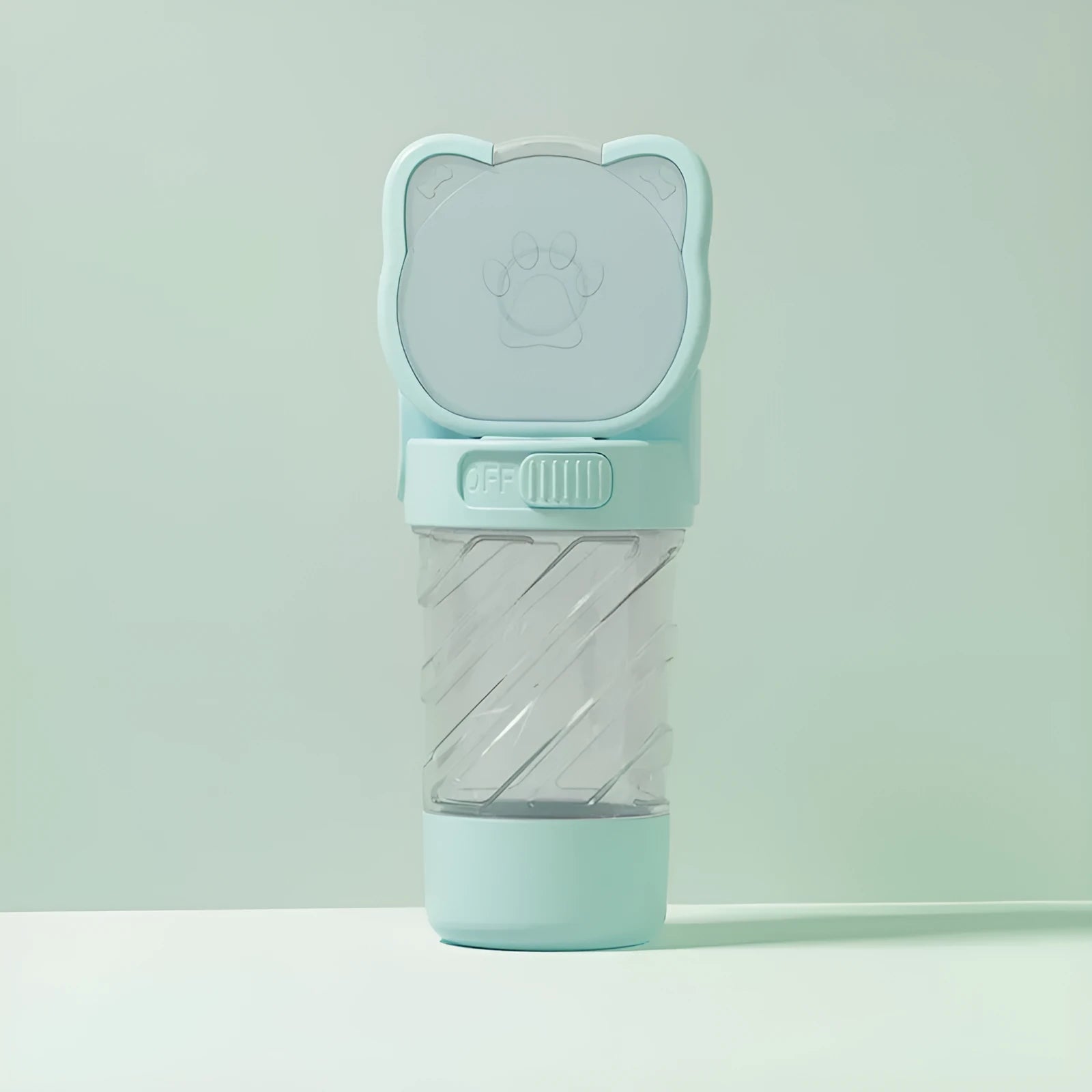 Green 3-in-1 portable pet water bottle with food container and waste bag dispenser, held by its hand strap.