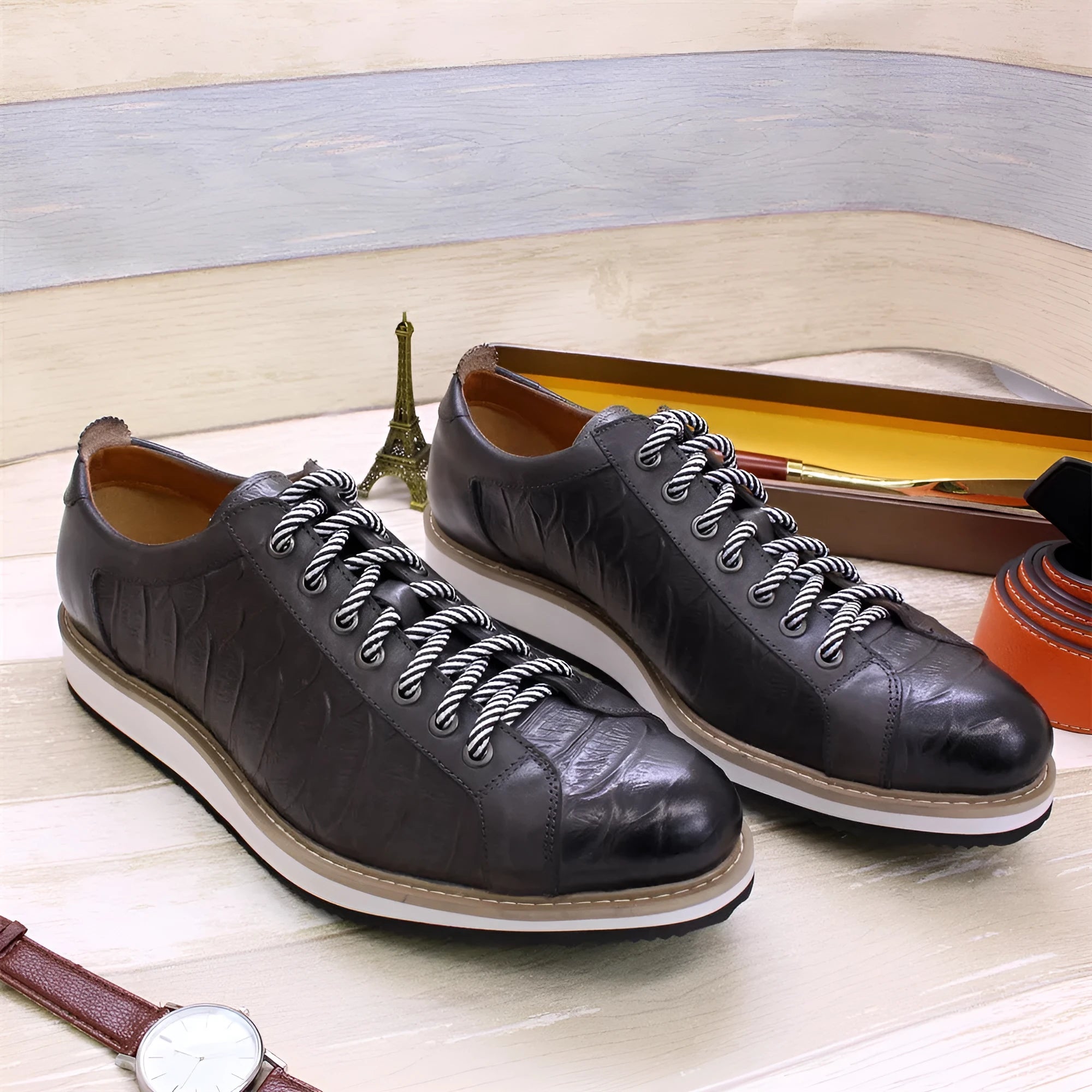 Men's low-top shoes with a handmade embossed pattern on the upper and front lace closure.
