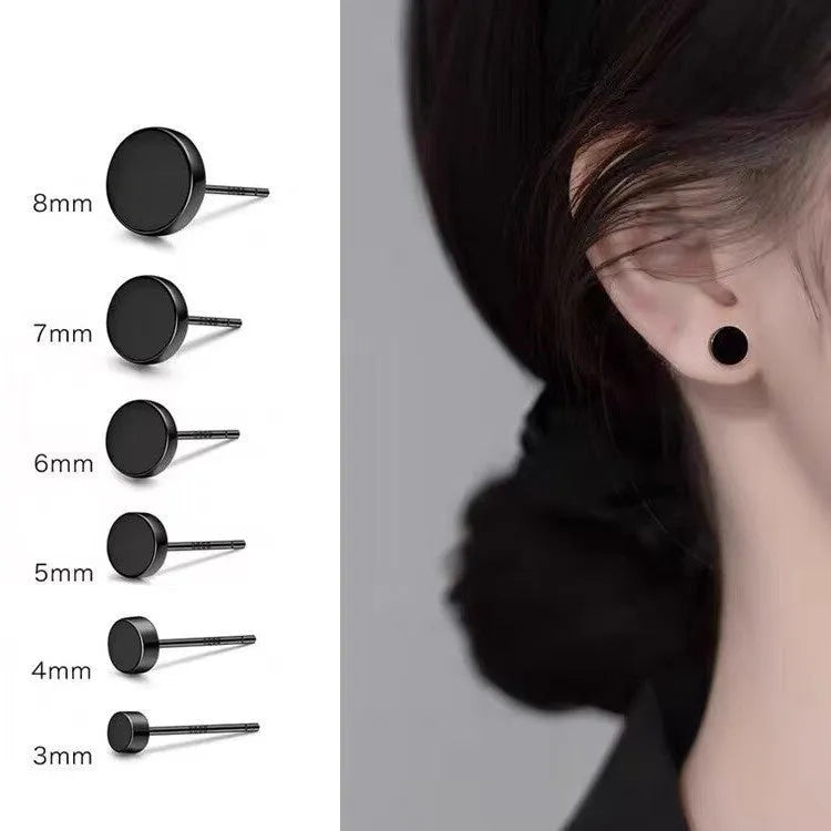 A pair of simple, round, flat-fronted S999 sterling silver ear bone studs on a plain background.