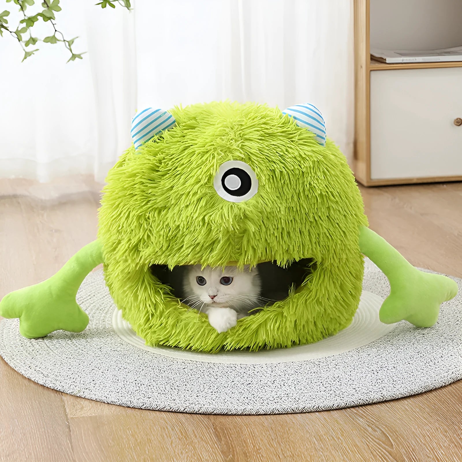 Fluffy round plush pet bed for cats and small dogs on a wooden floor