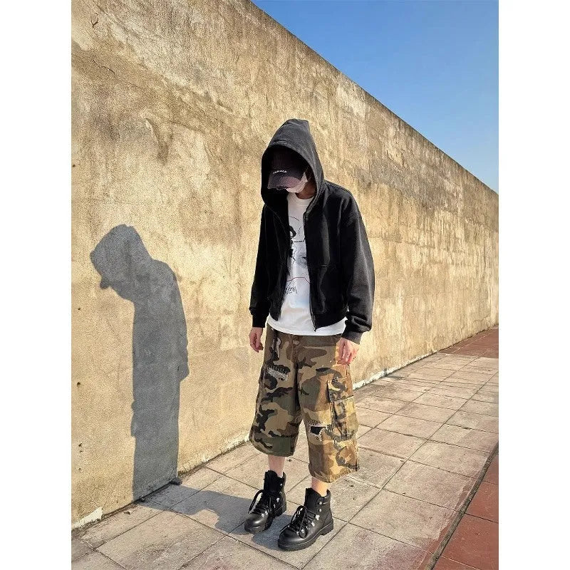 Men's camouflage cropped jeans with patchwork detailing and distressed rips in loose straight-leg fit