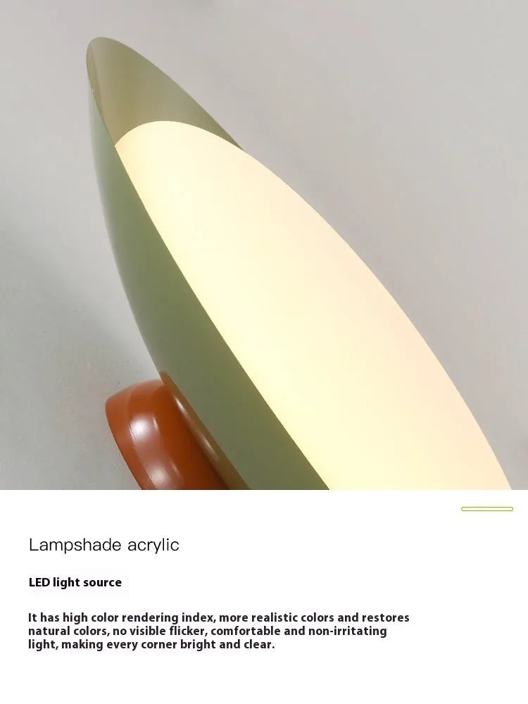 Modern flying saucer shaped ceiling lamp with an iron shade, shown in a cream yellow finish.