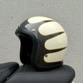 Glass fibre retro half motorcycle helmet shown in multiple colour options including cement grey and matte black flower patterns