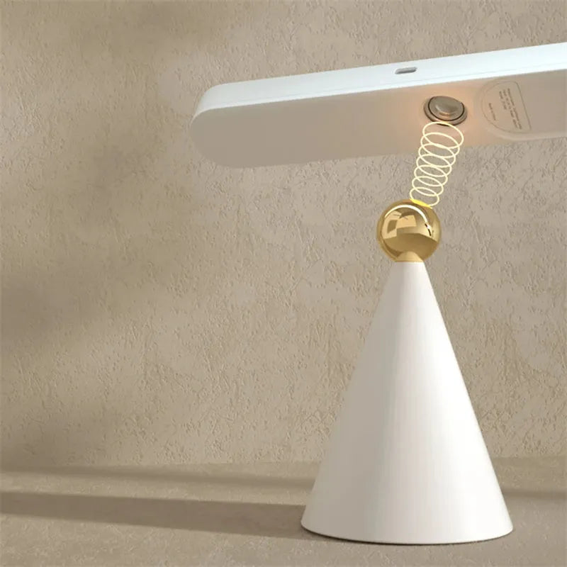 Geometric wireless table lamp with magnetic base in white colour showing touch controls
