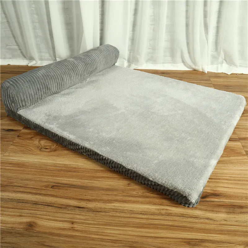 Corduroy dog bed sofa with bolster sides and non-slip base in a neutral colour.