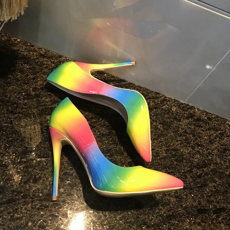 Rainbow patent leather women's ultra-high heel shoes with pointed toe and thin stiletto heel.