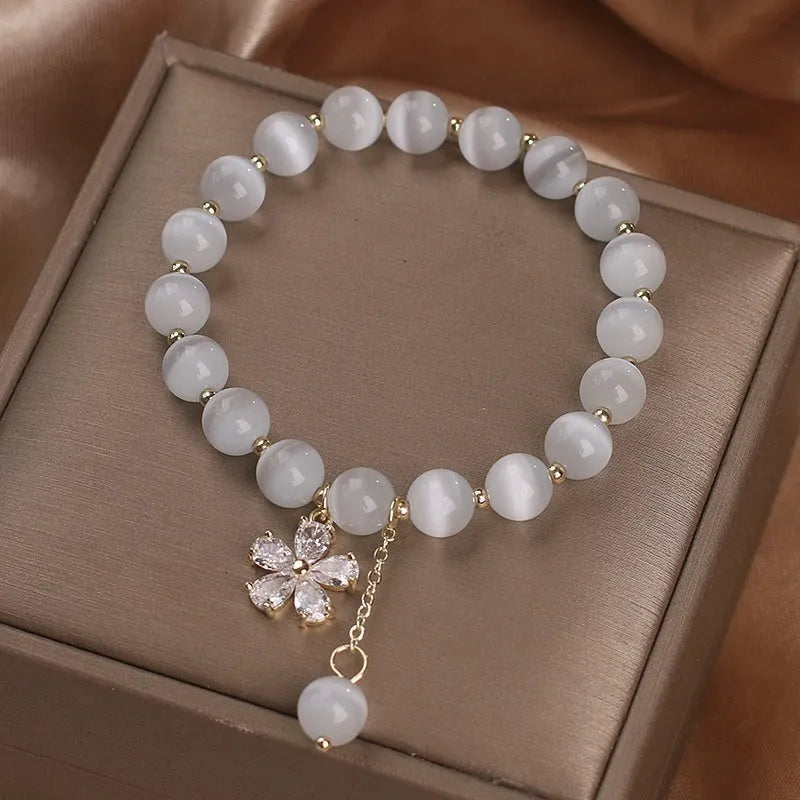White cat's eye stone bracelet with flower tassel design and morganite safety buckle