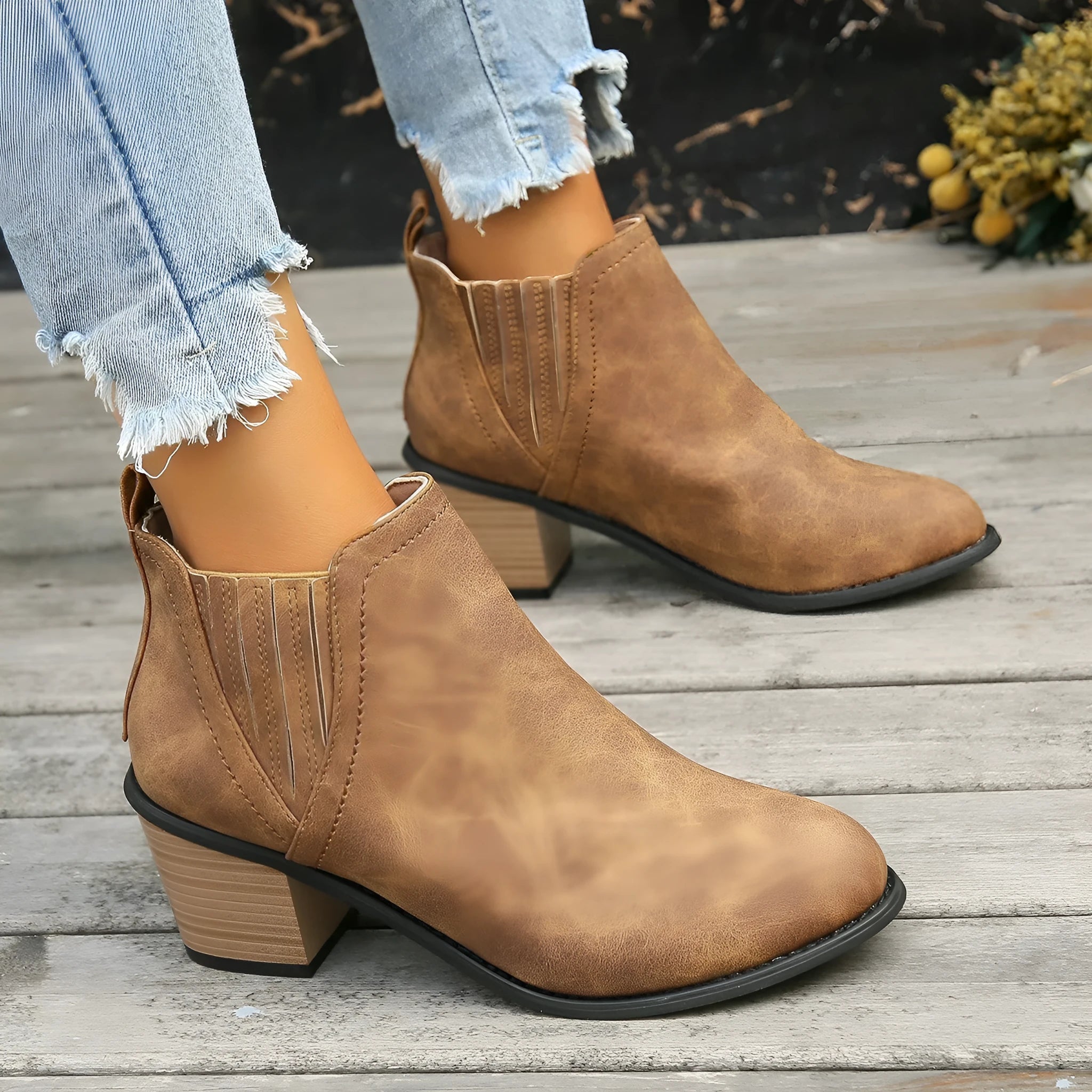 Black women's ankle boots with a pointed toe, thick square low heel, and slip-on design on a white background.