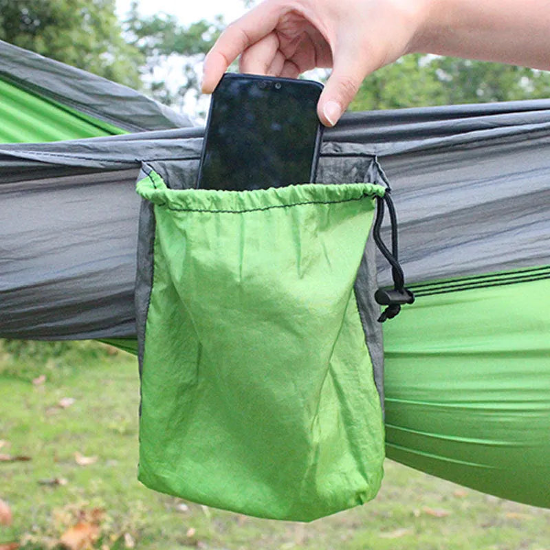 Blue nylon parachute cloth outdoor hammock with reinforced stitching hung between trees