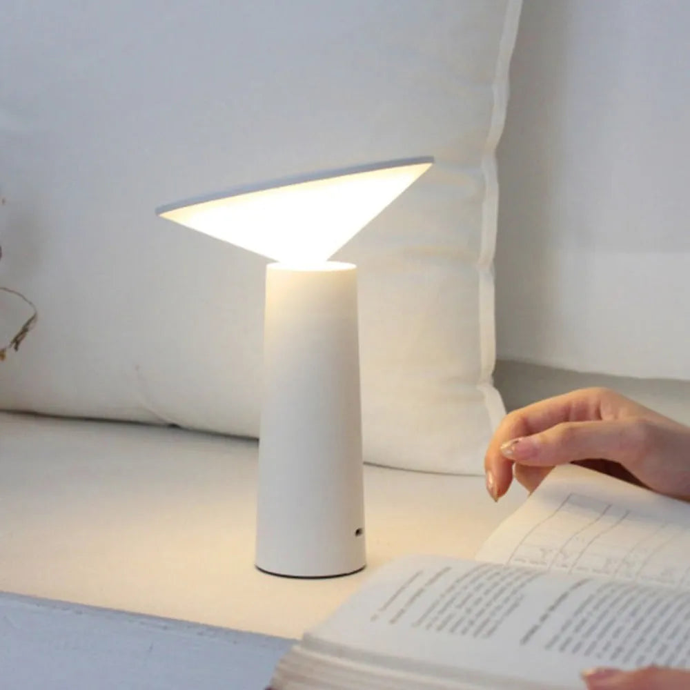 Black or white USB rechargeable LED desk lamp with a touch-sensitive base and a tilting lamp head.