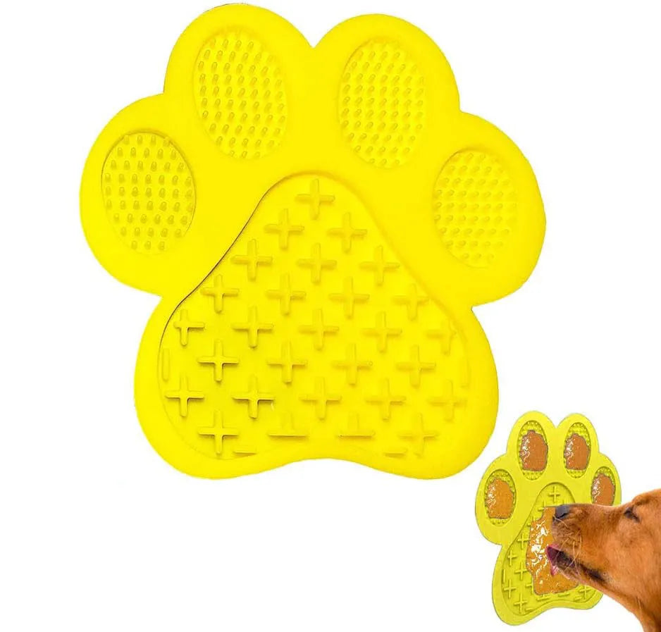 Blue silicone dog licking mat with bone texture and suction cups on the back, placed on a tiled wall.