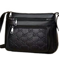 Women's black PU leather crossbody shoulder bag with embossed pattern and phone pocket