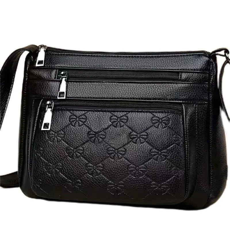 Women's black PU leather crossbody shoulder bag with embossed pattern and phone pocket