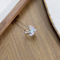 Copper adjustable insect ring on a finger, showing its irregular design and adjustable opening.