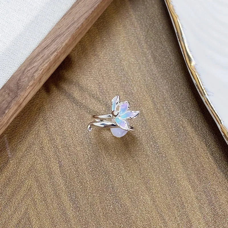 Copper adjustable insect ring on a finger, showing its irregular design and adjustable opening.