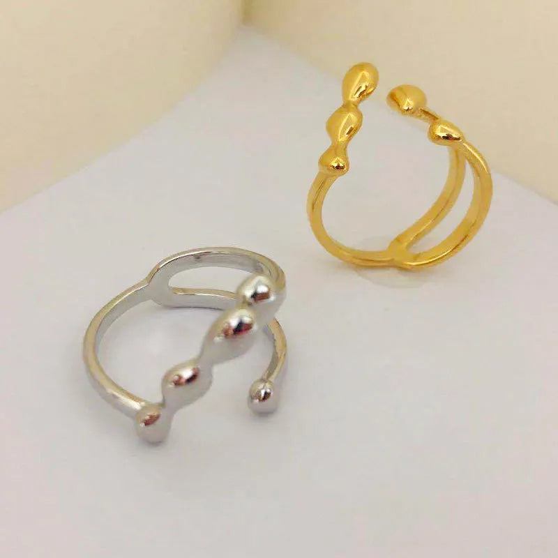 Brass opening ring with spherical design elements in gold finish